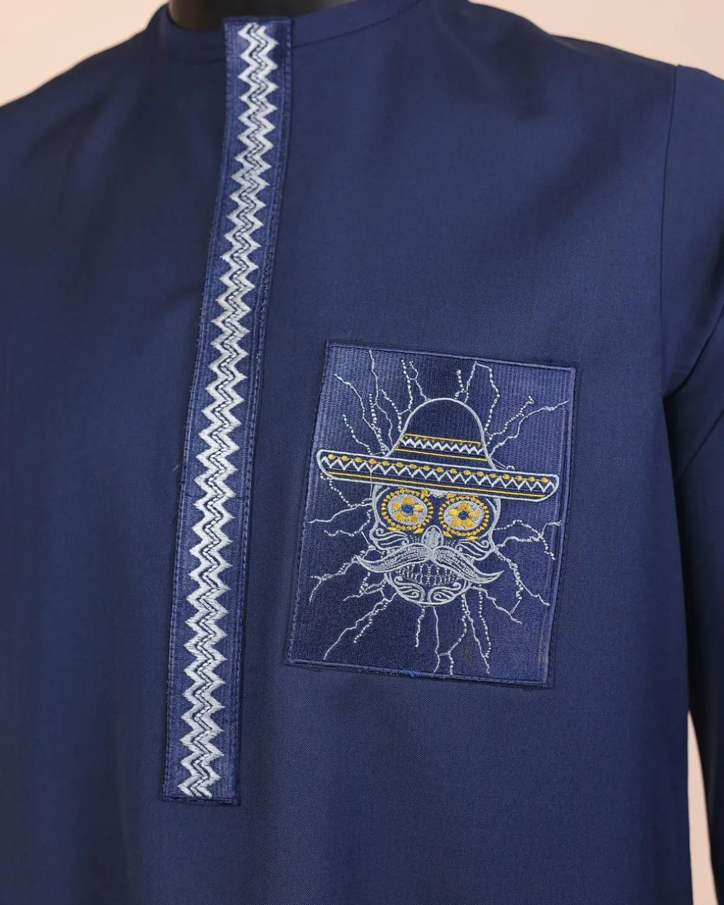 A Navy blue, vexing demagogue pocket and flap embrodery, long sleeve African senator kaftan native.