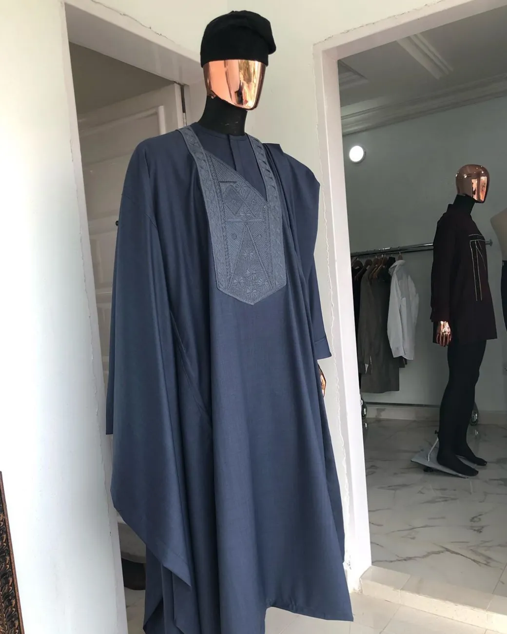 A Navy Blue with connected embroidery Agbada and Hand woven Yoruba Hat