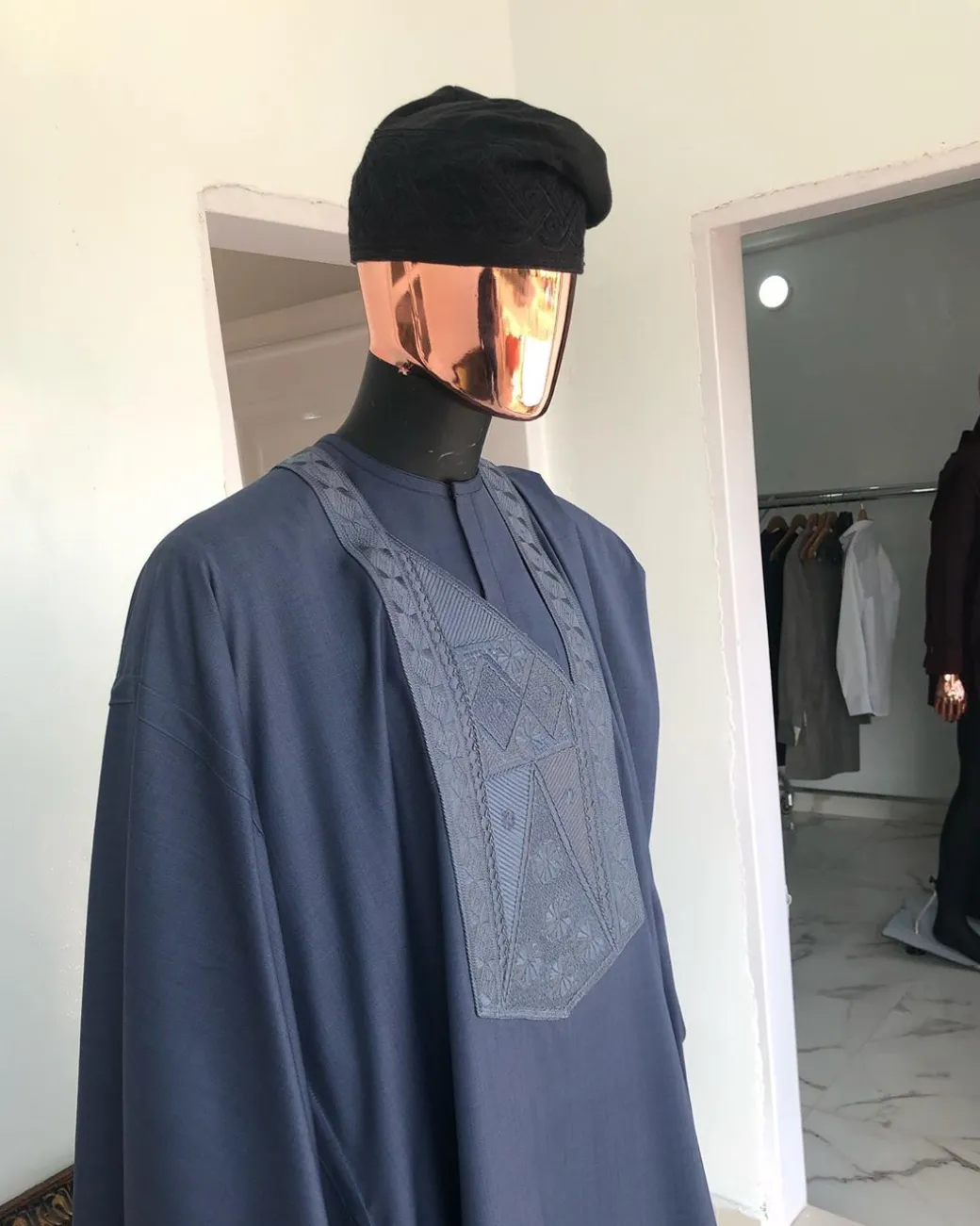 A Navy Blue with connected embroidery Agbada and Hand woven Yoruba Hat