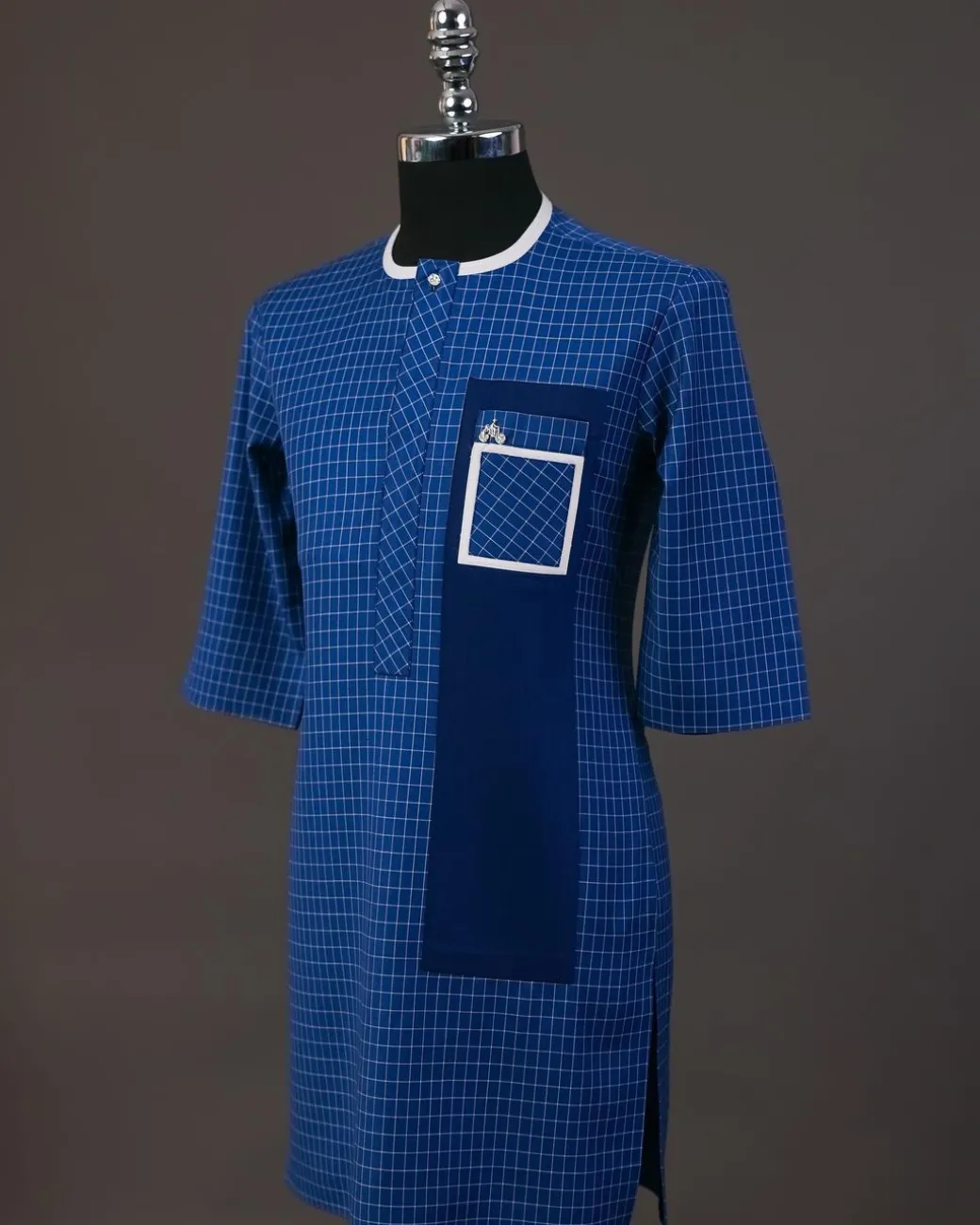 A Neon blue, graph check, front flap with Swarovski button details, and layered pocket traditional senator kaftan native
