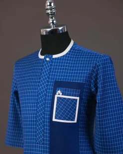A Neon blue, graph check, front flap with Swarovski button details, and layered pocket traditional senator kaftan native
