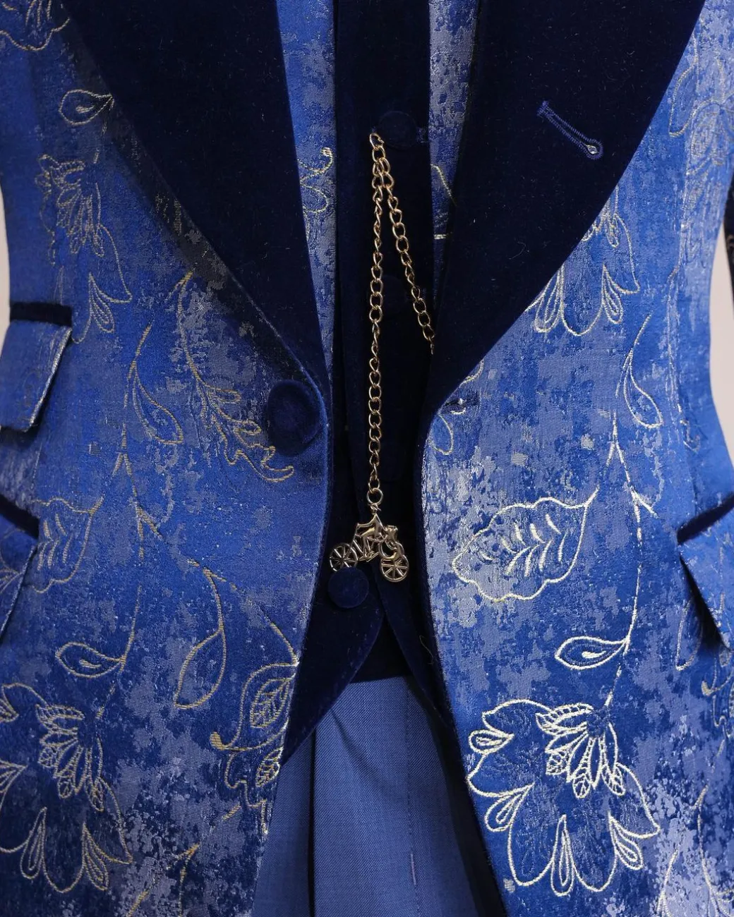 A peak lapel dispersed Sky blue and splashed champagne gold metallic jacquard tuxedo suit
