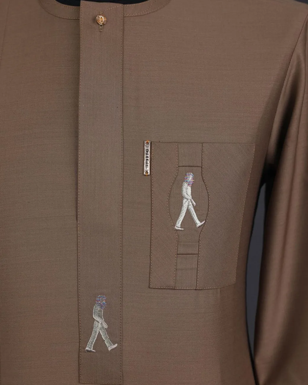 A Peanut brown, front flap, walking paul embroidery details, 3/4 sleeve African senator kaftan native.