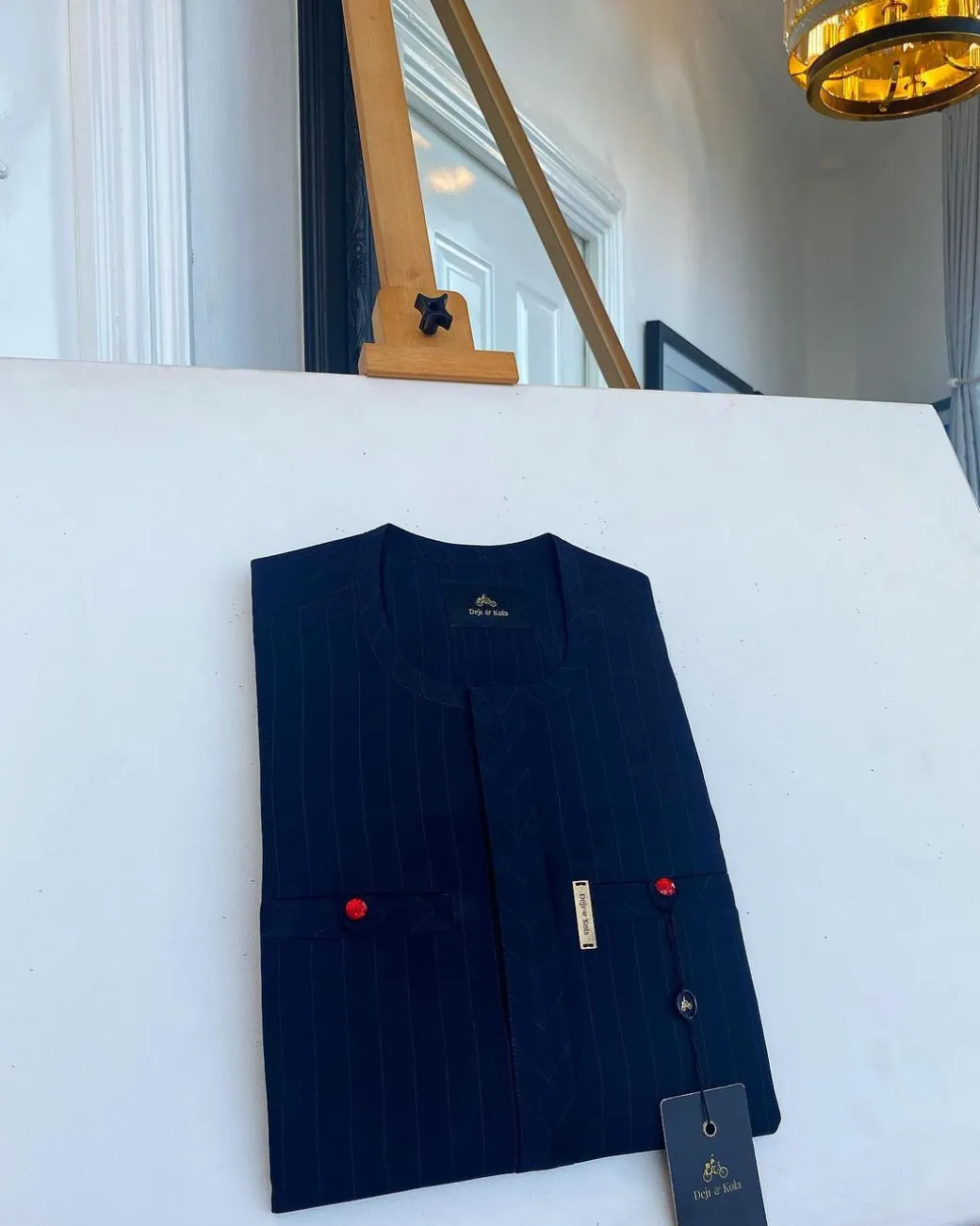 A pencil stripe midnight blue owl eye, double pocket, front flap African traditional senator kaftan native.