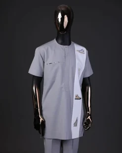 A pewter grey front flap with gold Swarovski button detailing and side all-stars embroidery detailing on white kaftan and Sokoto