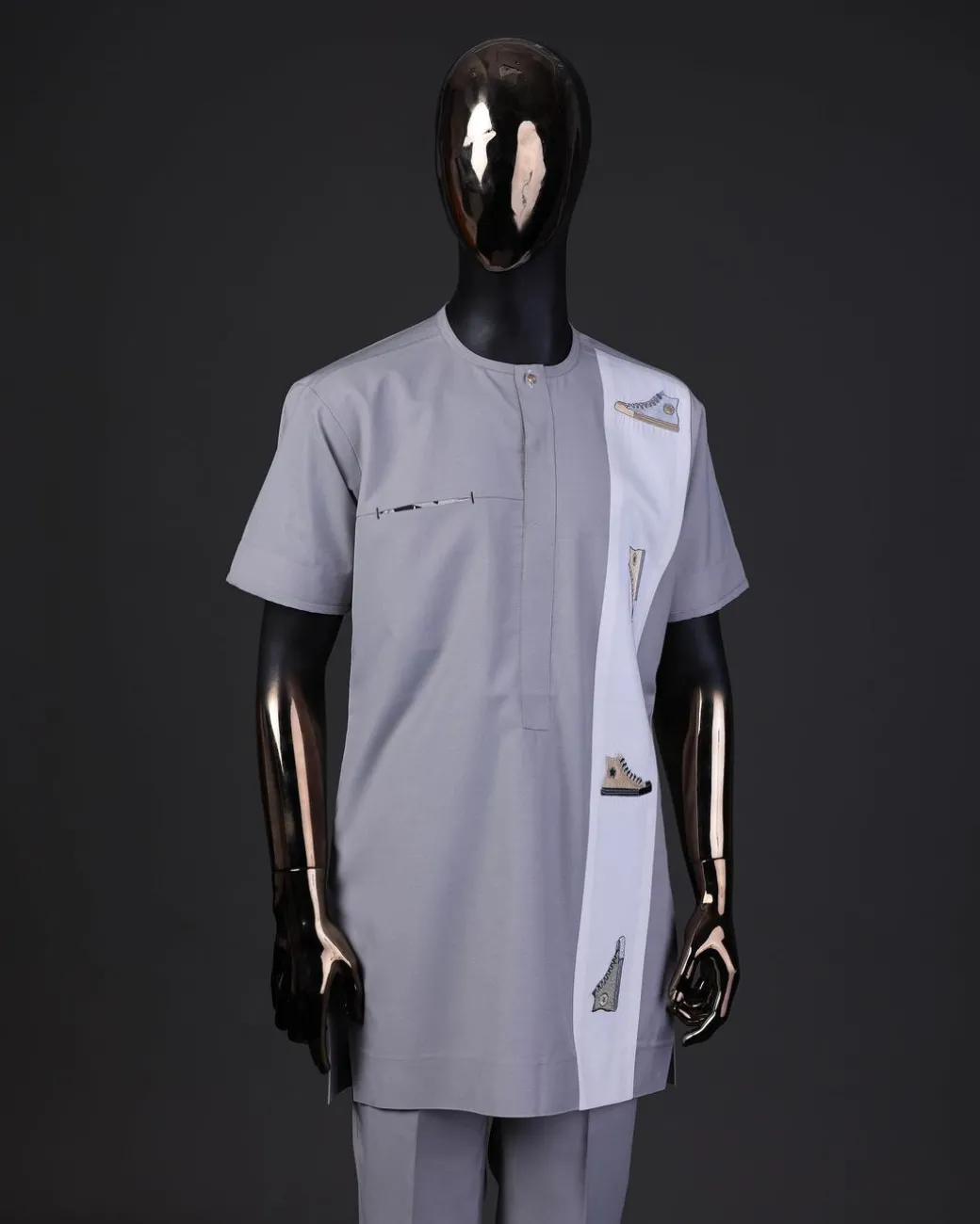 A pewter grey front flap with gold Swarovski button detailing and side all-stars embroidery detailing on white kaftan and Sokoto