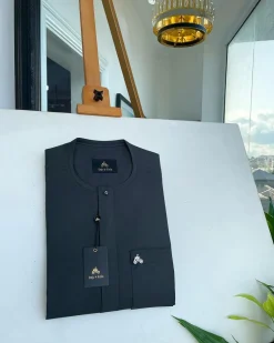 A Phthalo green, front flap and patch pocket with black Swarovski button detailing senator kaftan native.