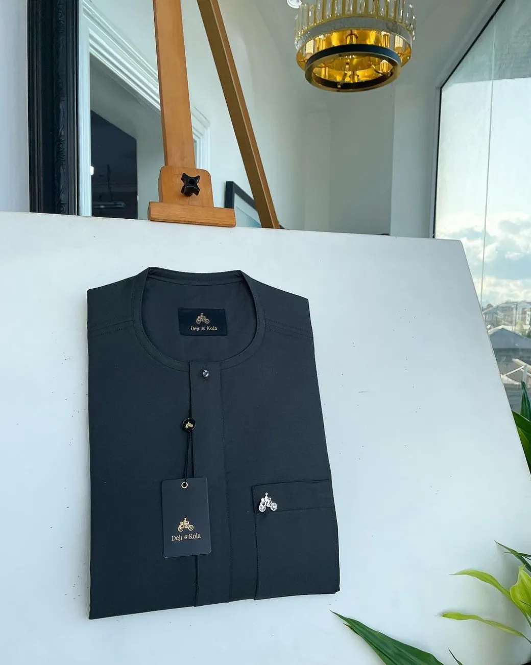 A Phthalo green, front flap and patch pocket with black Swarovski button detailing senator kaftan native.