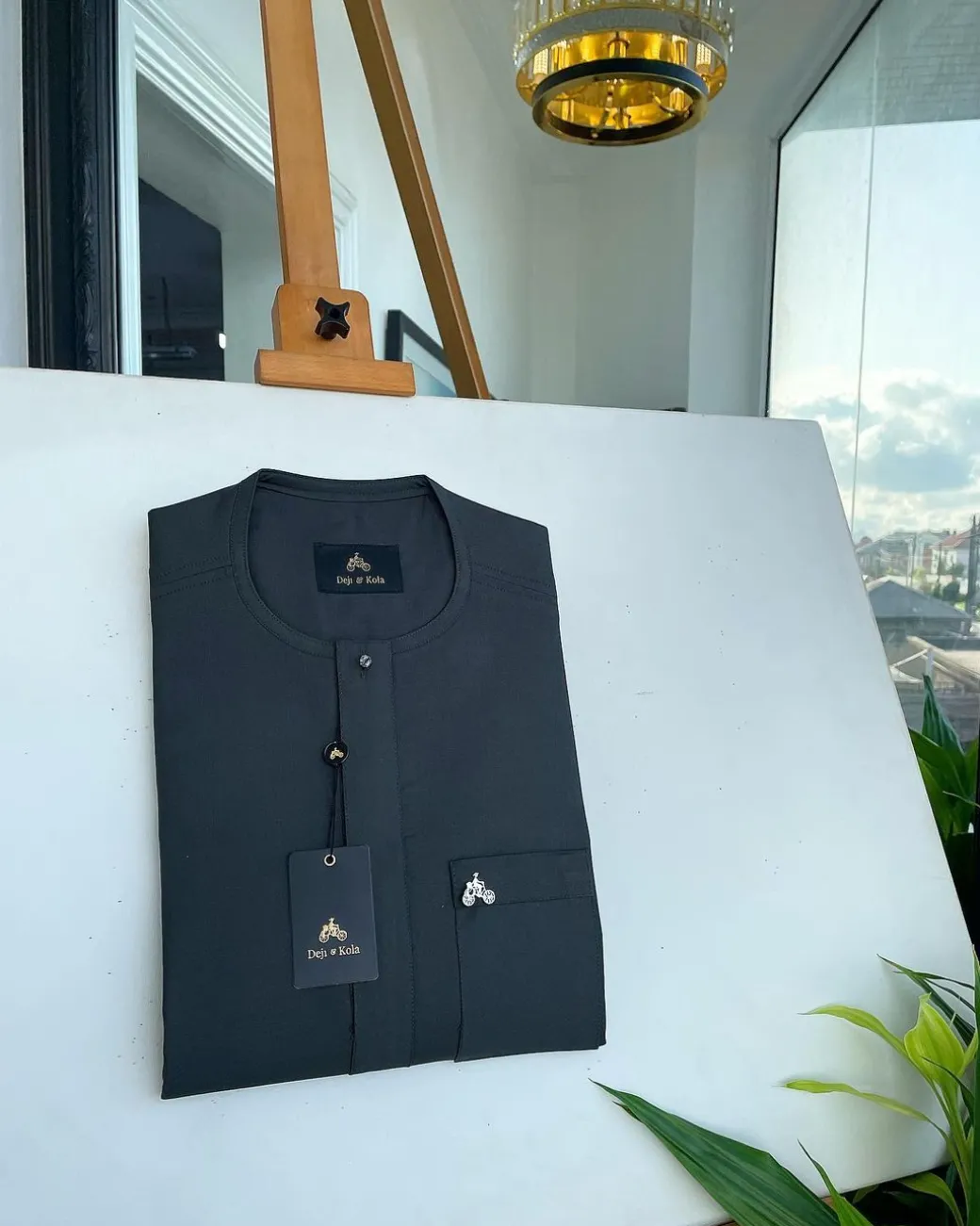 A Phthalo green, front flap and patch pocket with black Swarovski button detailing senator kaftan native.