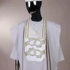A porcelain, connected medulla and wooven pattern embroidery detailing agbada