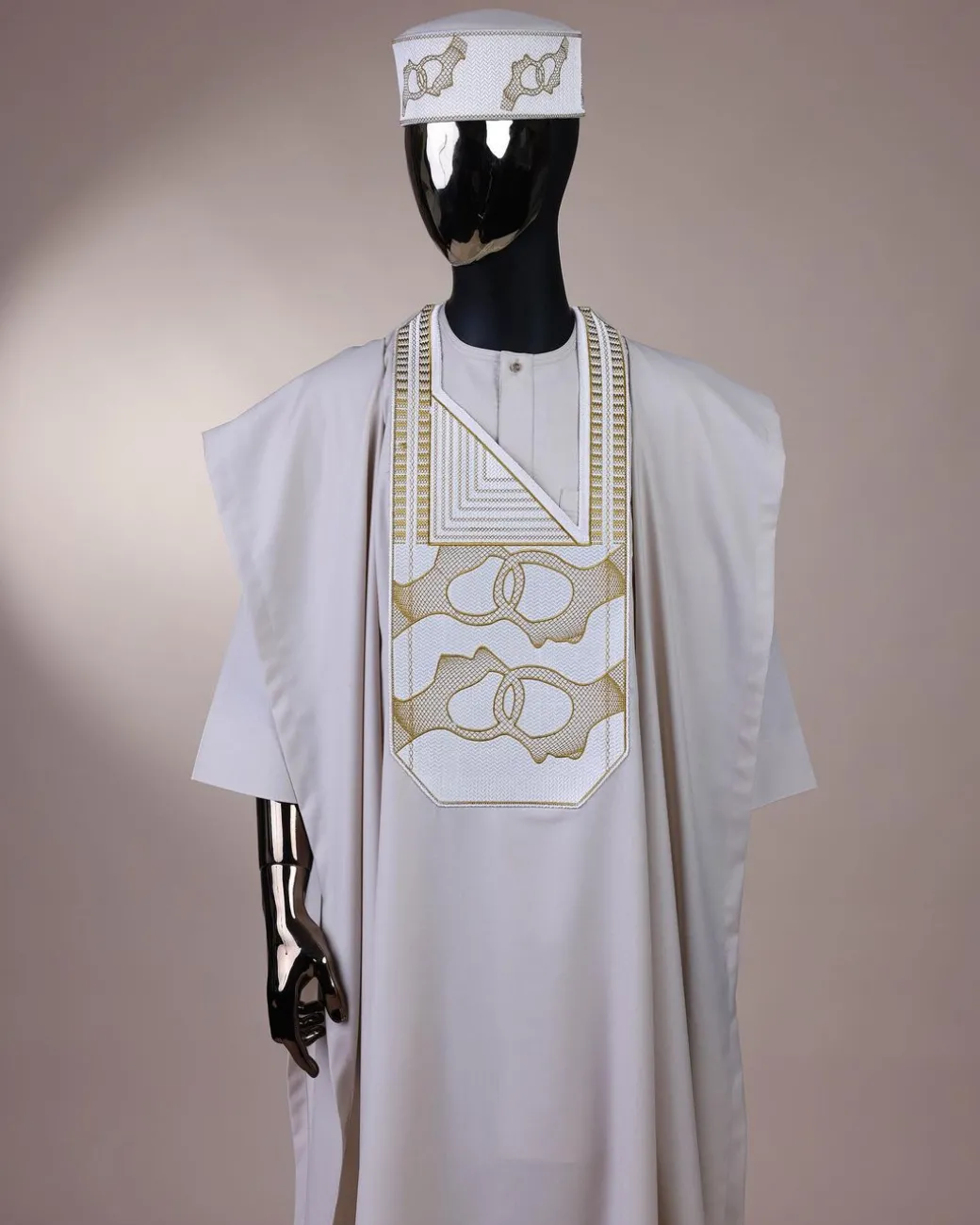 A porcelain, connected medulla and wooven pattern embroidery detailing agbada