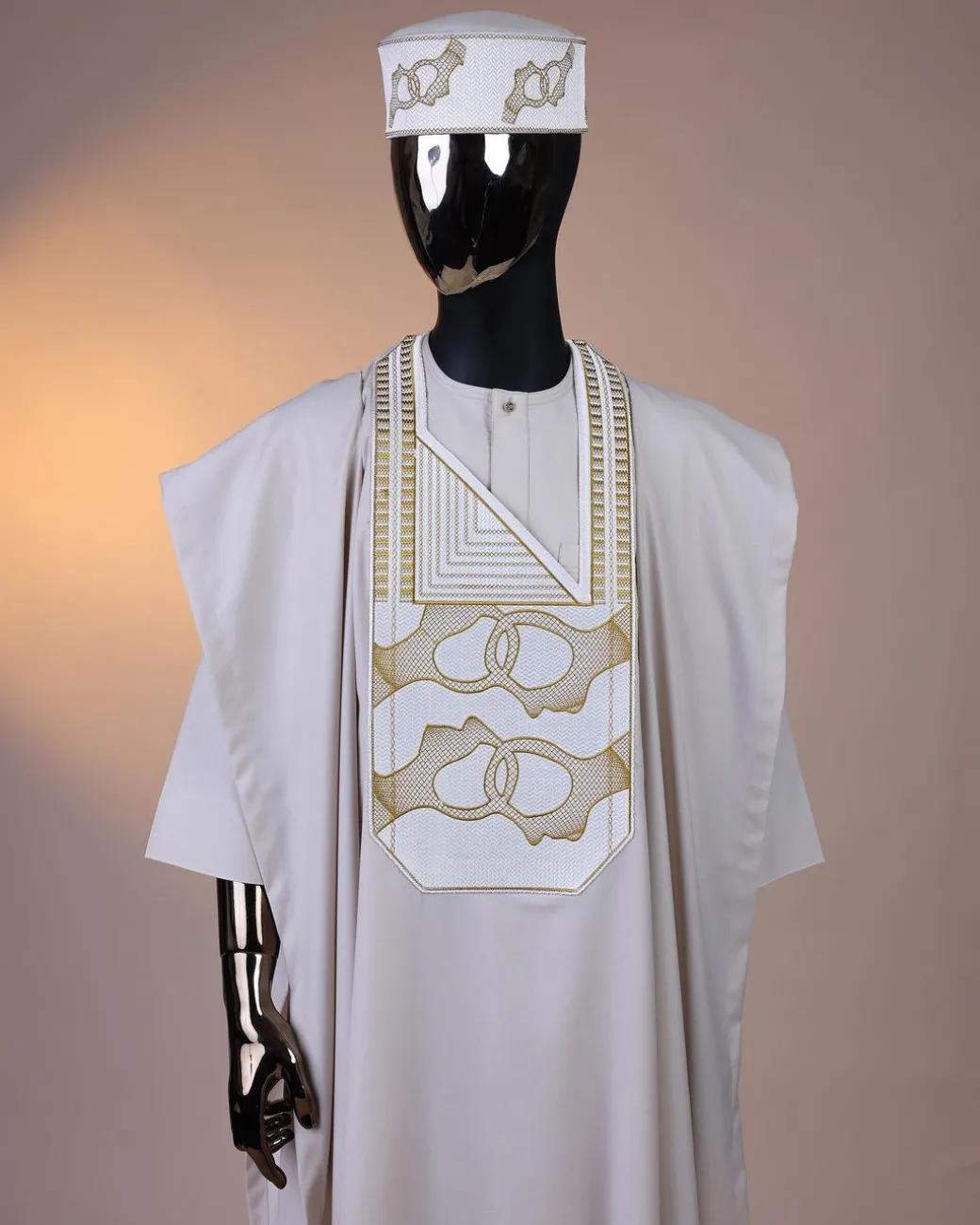 A porcelain, connected medulla and wooven pattern embroidery detailing agbada