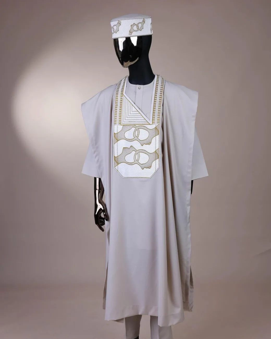 A porcelain, connected medulla and wooven pattern embroidery detailing agbada