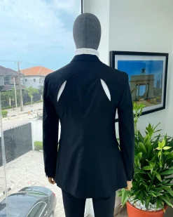 A “power” front and back slit charcoal black, long cross strap peak lapel suit