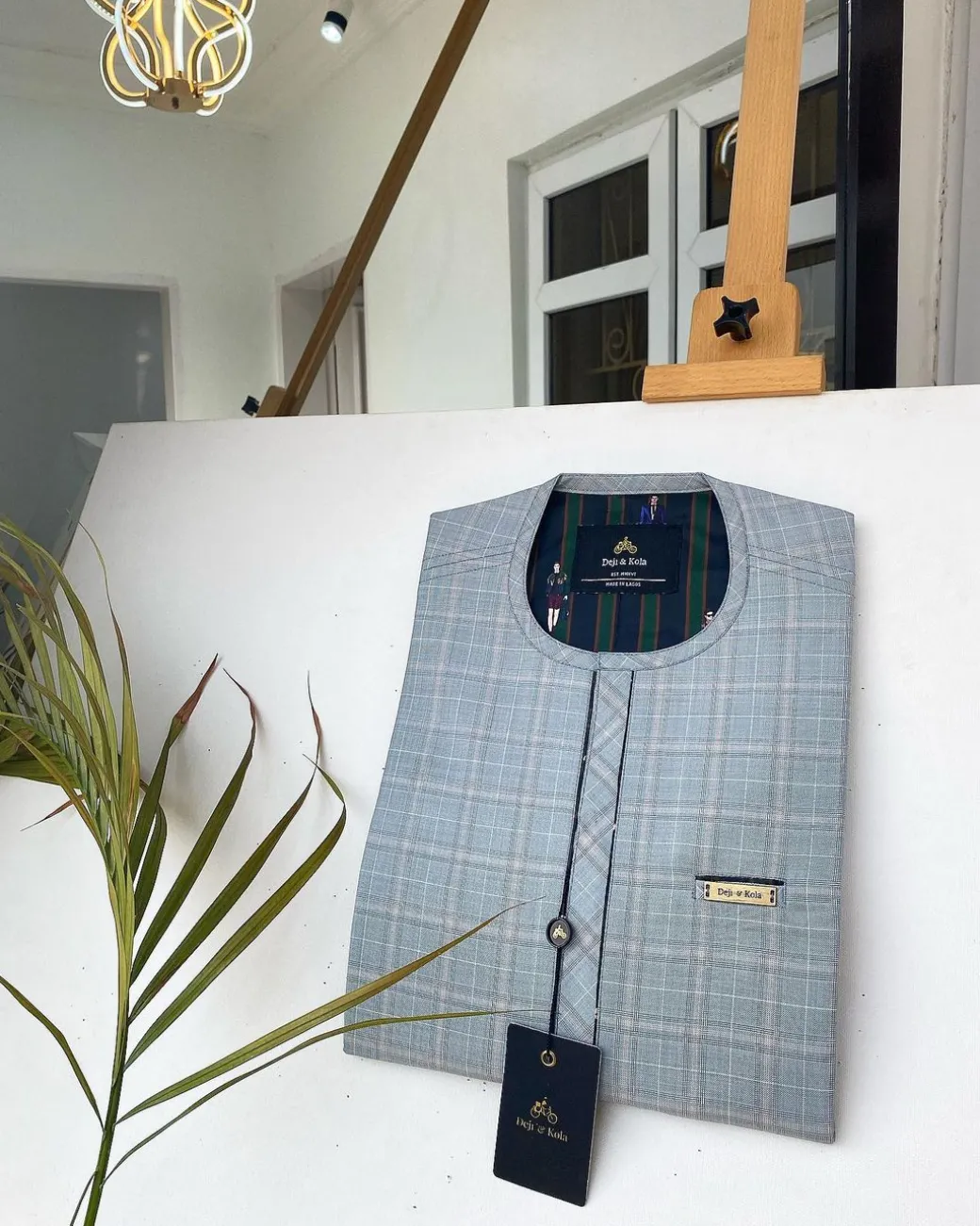 A Prince Charles check fabric kaftan with a cornerpiece flap design
