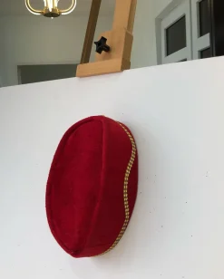 A Red and gold lines ceremonial African Traditional hat