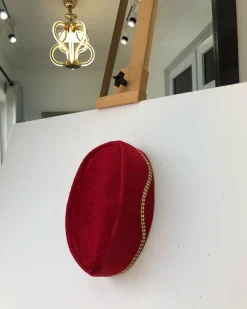 A Red and gold lines ceremonial African Traditional hat