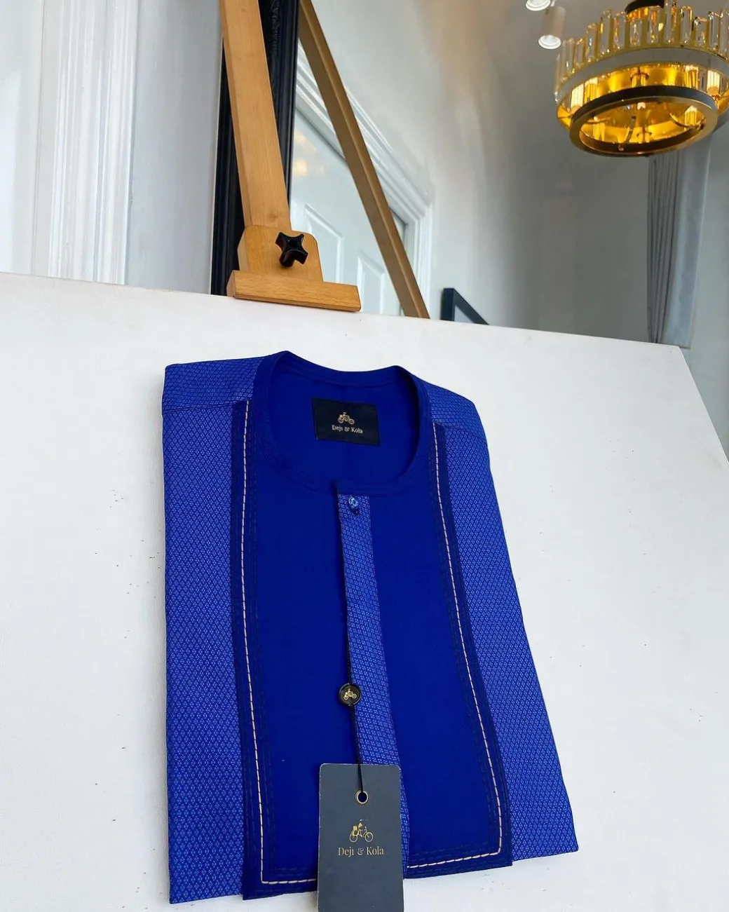 A related shade of blue rectangular front flap with clear view Swarovski button senator kaftan native