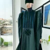 A reloaded British racing green Monochrome embroidery with soaked Italian velvet detailing agbada
