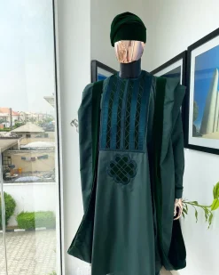 A reloaded British racing green Monochrome embroidery with soaked Italian velvet detailing agbada