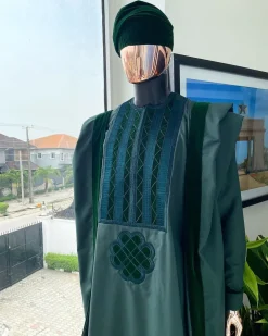 A reloaded British racing green Monochrome embroidery with soaked Italian velvet detailing agbada
