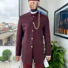 A Reloaded Ceremonial “Ayeye” Ijade 20/21 – Look 10- “Ajala”. A burgundy safari jacket with gold buttons, inner waist coat, turtle neck shirt, hat and pant trousers.