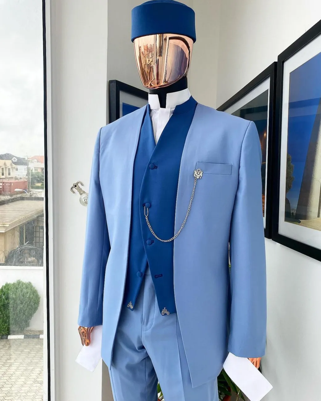 A reloaded ceremonial “Ayeye” Ijade 20/21 – Look 5- “Tokunbo” look. Powder blue half section back slant cut jacket