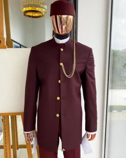 A Reloaded Ceremonial “Ayeye” Ijade 20/21 – Look 10- “Ajala”. A burgundy safari jacket with gold buttons, inner waist coat, turtle neck shirt, hat and pant trousers.