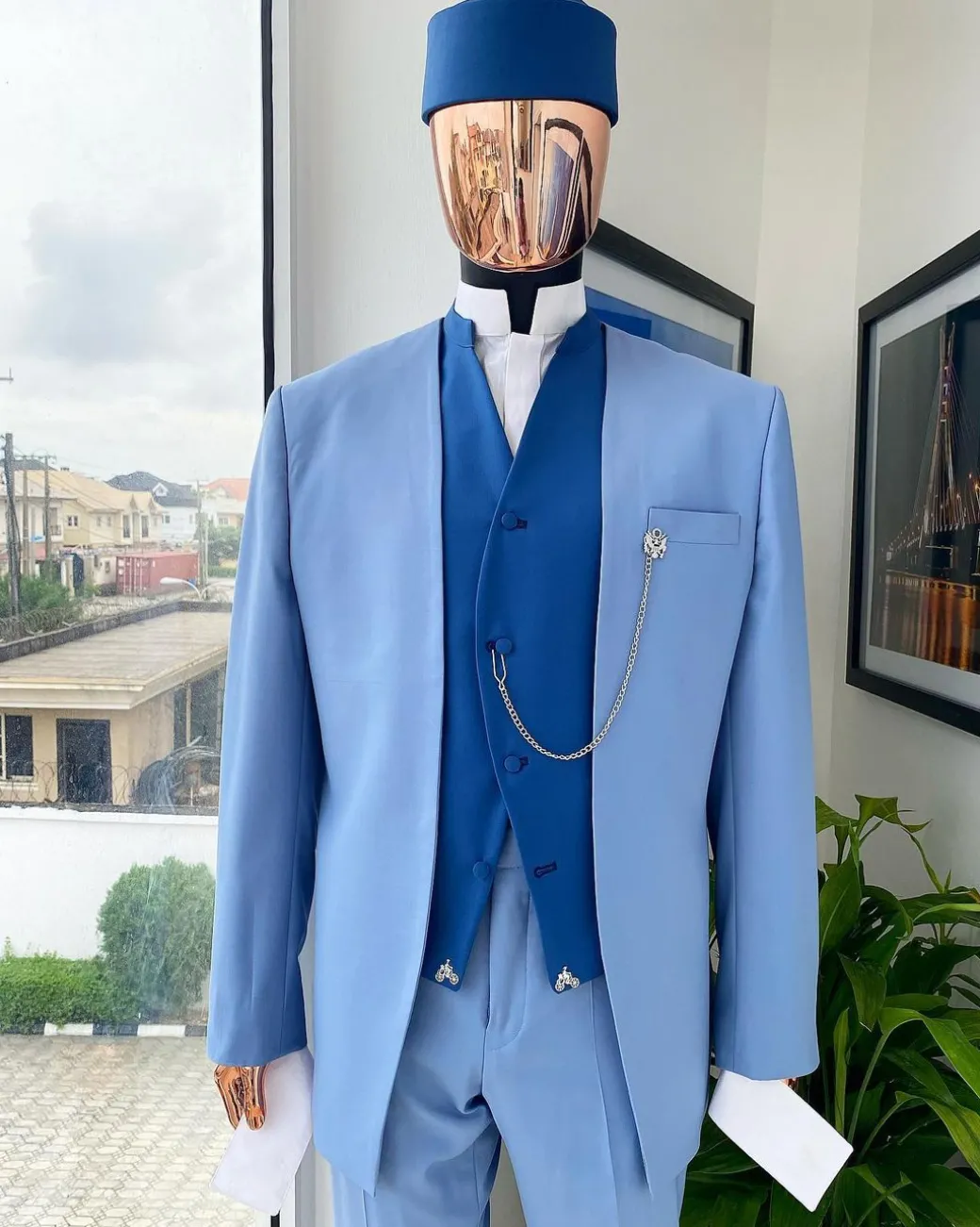 A reloaded ceremonial “Ayeye” Ijade 20/21 – Look 5- “Tokunbo” look. Powder blue half section back slant cut jacket
