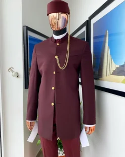 A Reloaded Ceremonial “Ayeye” Ijade 20/21 – Look 10- “Ajala”. A burgundy safari jacket with gold buttons, inner waist coat, turtle neck shirt, hat and pant trousers.