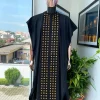 A Reloaded charcoal black, connected square embroidery design with matching gold and red Swarovski stone details agbada