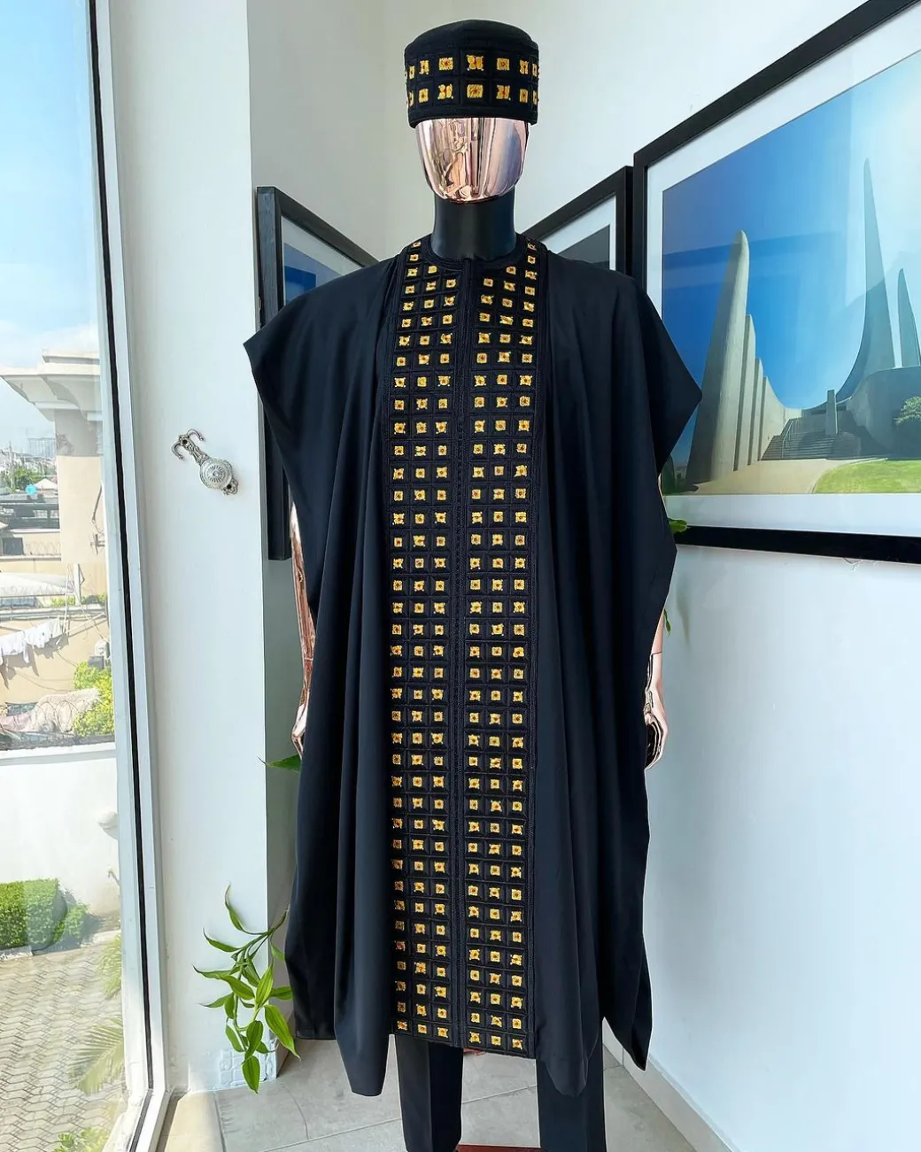 A Reloaded charcoal black, connected square embroidery design with matching gold and red Swarovski stone details agbada