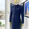 A reloaded monochrome “peaky Blinder” midnight blue peak lapel trench suit