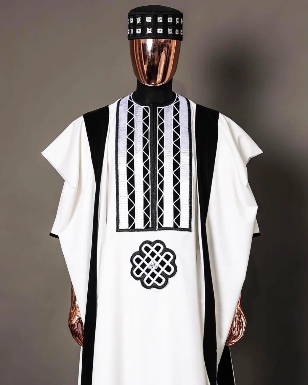 A Reloaded white Monochrome embroidery with charcoal black soaked Italian velvet detailing agbada