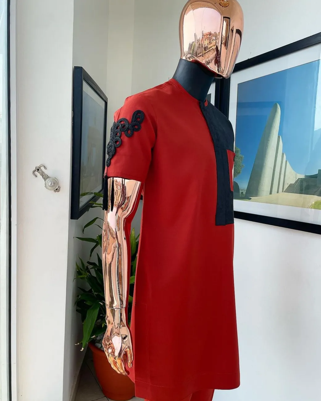 A Rosso corsa red, half cut black paisley detailing with mandarin knot button detailing african traditional senator kaftan native