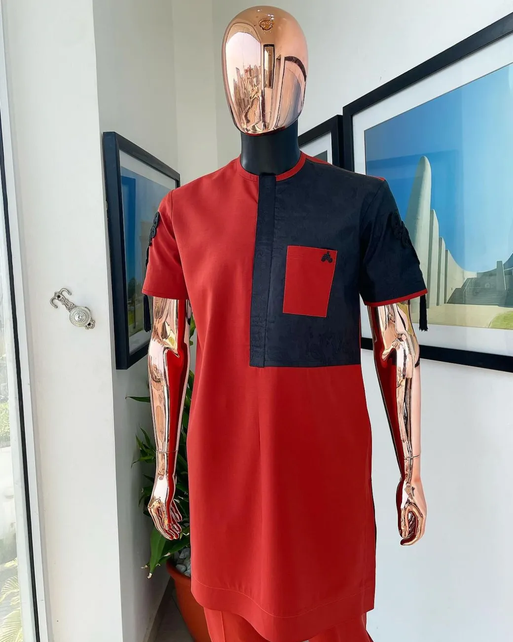 A Rosso corsa red, half cut black paisley detailing with mandarin knot button detailing african traditional senator kaftan native
