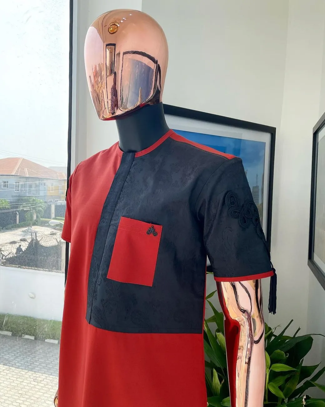 A Rosso corsa red, half cut black paisley detailing with mandarin knot button detailing african traditional senator kaftan native