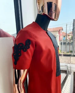 A Rosso corsa red, half cut black paisley detailing with mandarin knot button detailing african traditional senator kaftan native