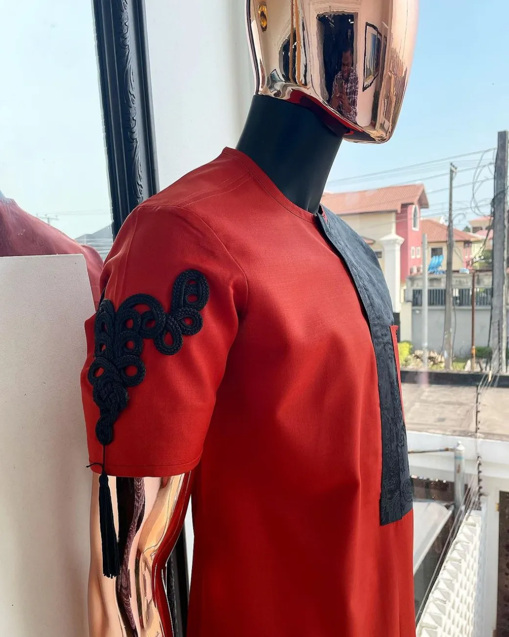 A Rosso corsa red, half cut black paisley detailing with mandarin knot button detailing african traditional senator kaftan native