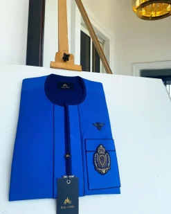 A Royal blue with navy blue mix, hand embroidery patch detailing, and black butterfly metal lapel African Kaftan