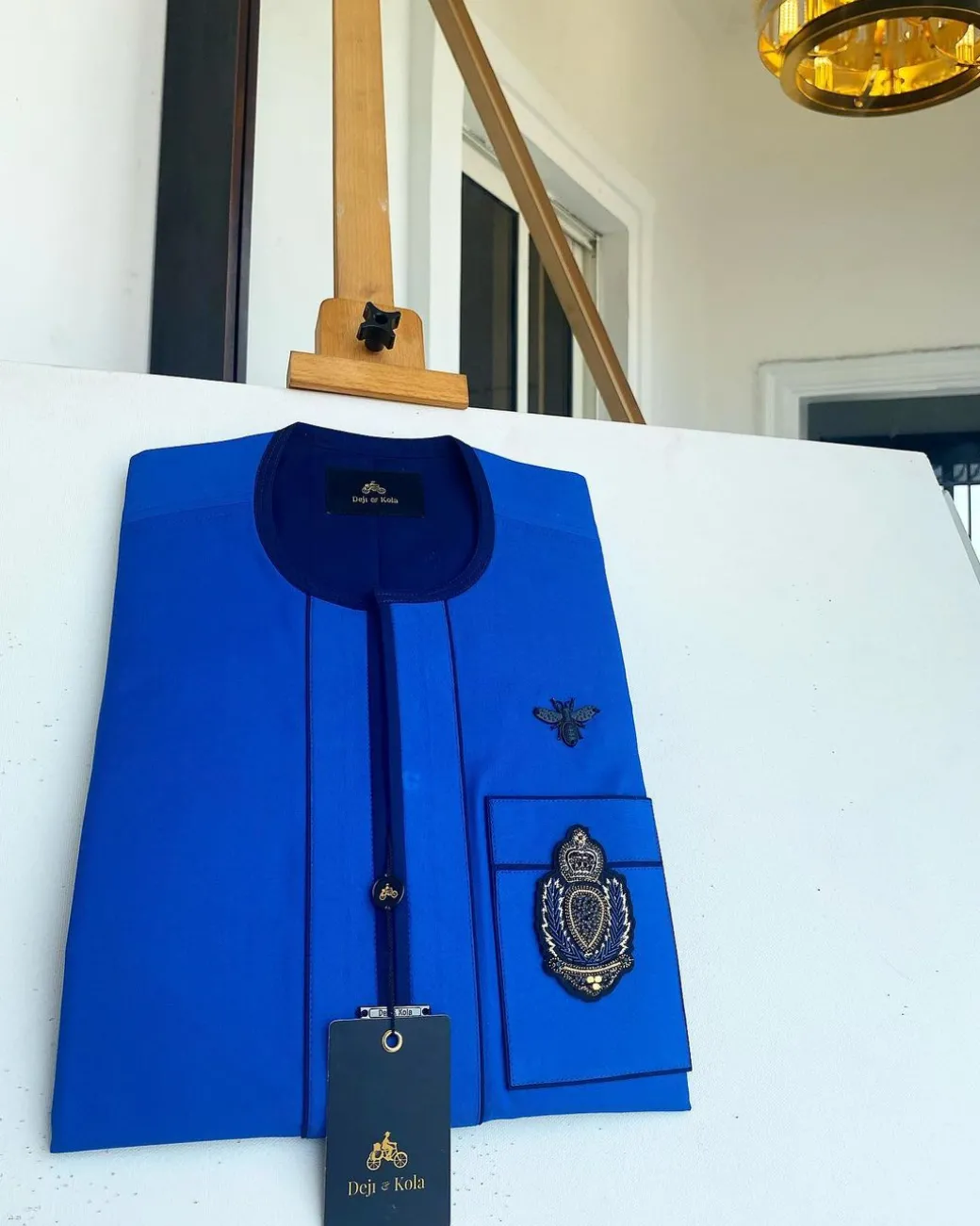 A Royal blue with navy blue mix, hand embroidery patch detailing, and black butterfly metal lapel African Kaftan
