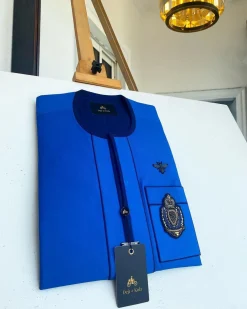 A Royal blue with navy blue mix, hand embroidery patch detailing, and black butterfly metal lapel African Kaftan