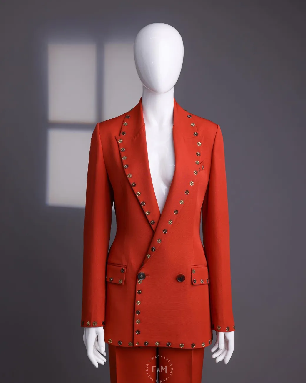 A rust orange peak lapel with shades of brown ss16 Swarovski stone details double-breasted jacket.