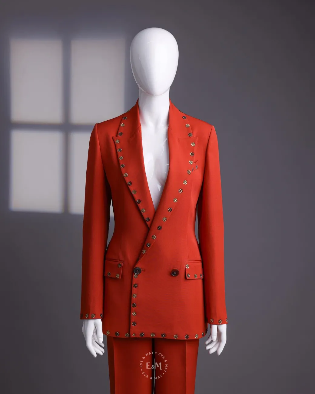 A rust orange peak lapel with shades of brown ss16 Swarovski stone details double-breasted jacket.