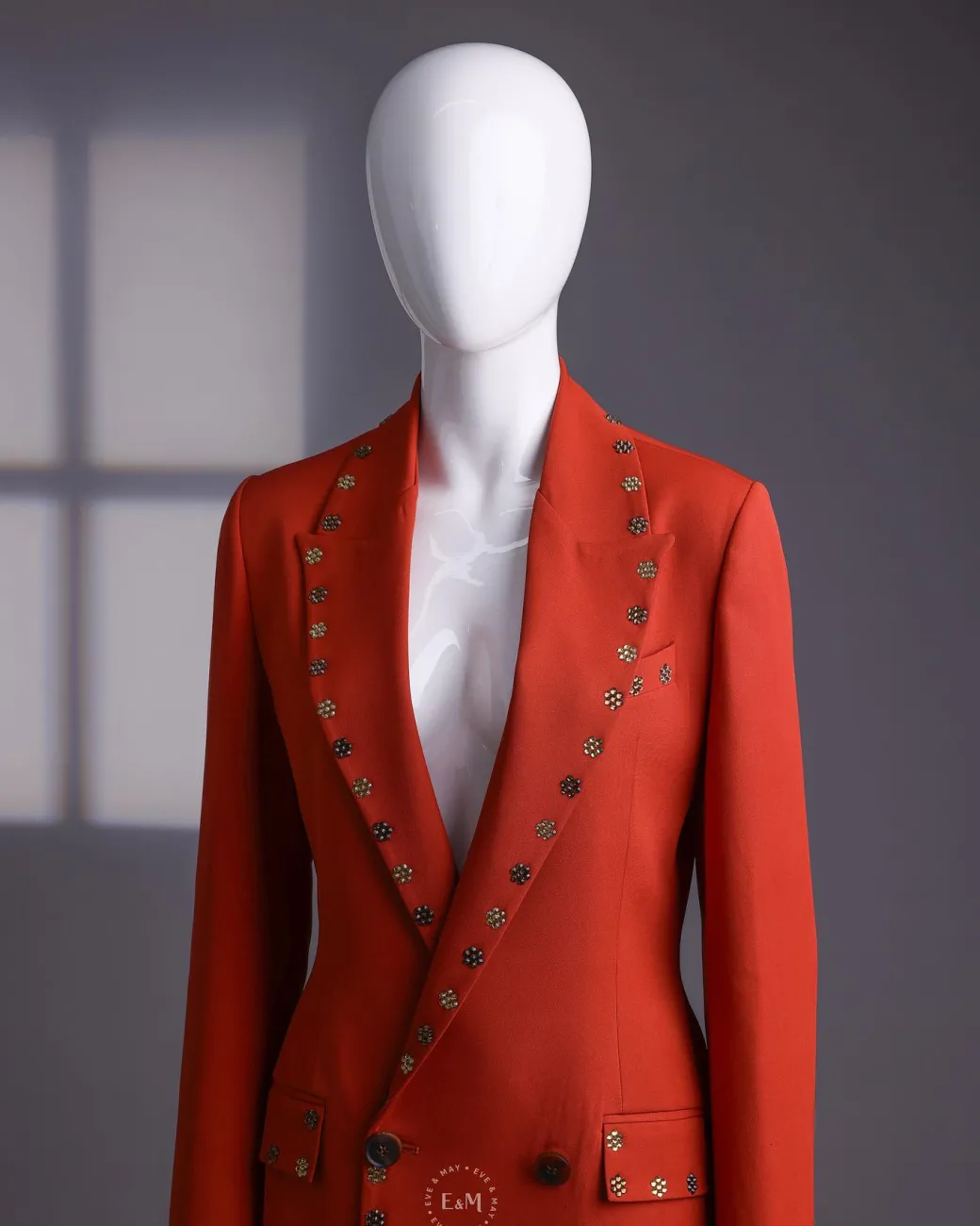 A rust orange peak lapel with shades of brown ss16 Swarovski stone details double-breasted jacket.