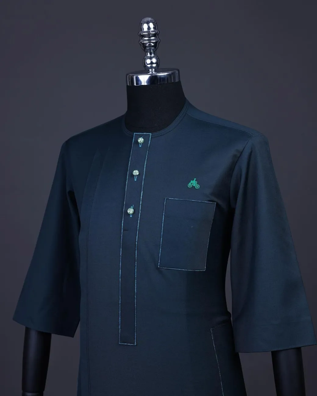 A Sacramento green, Front flap with green Swarovski buttons, patch pocket, 3/4 sleeve details African senator kaftan native.