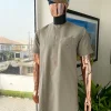 A Sand dollar beige, clear view Swarovski button with orange embroidery flap and pocket detailing African traditional senator kaftan native.