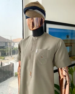 A Sand dollar beige, clear view Swarovski button with orange embroidery flap and pocket detailing African traditional senator kaftan native.
