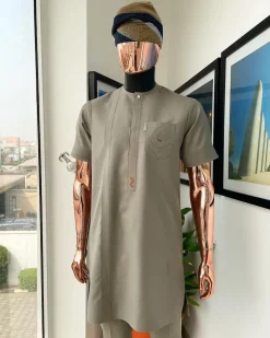 A Sand dollar beige, clear view Swarovski button with orange embroidery flap and pocket detailing African traditional senator kaftan native.
