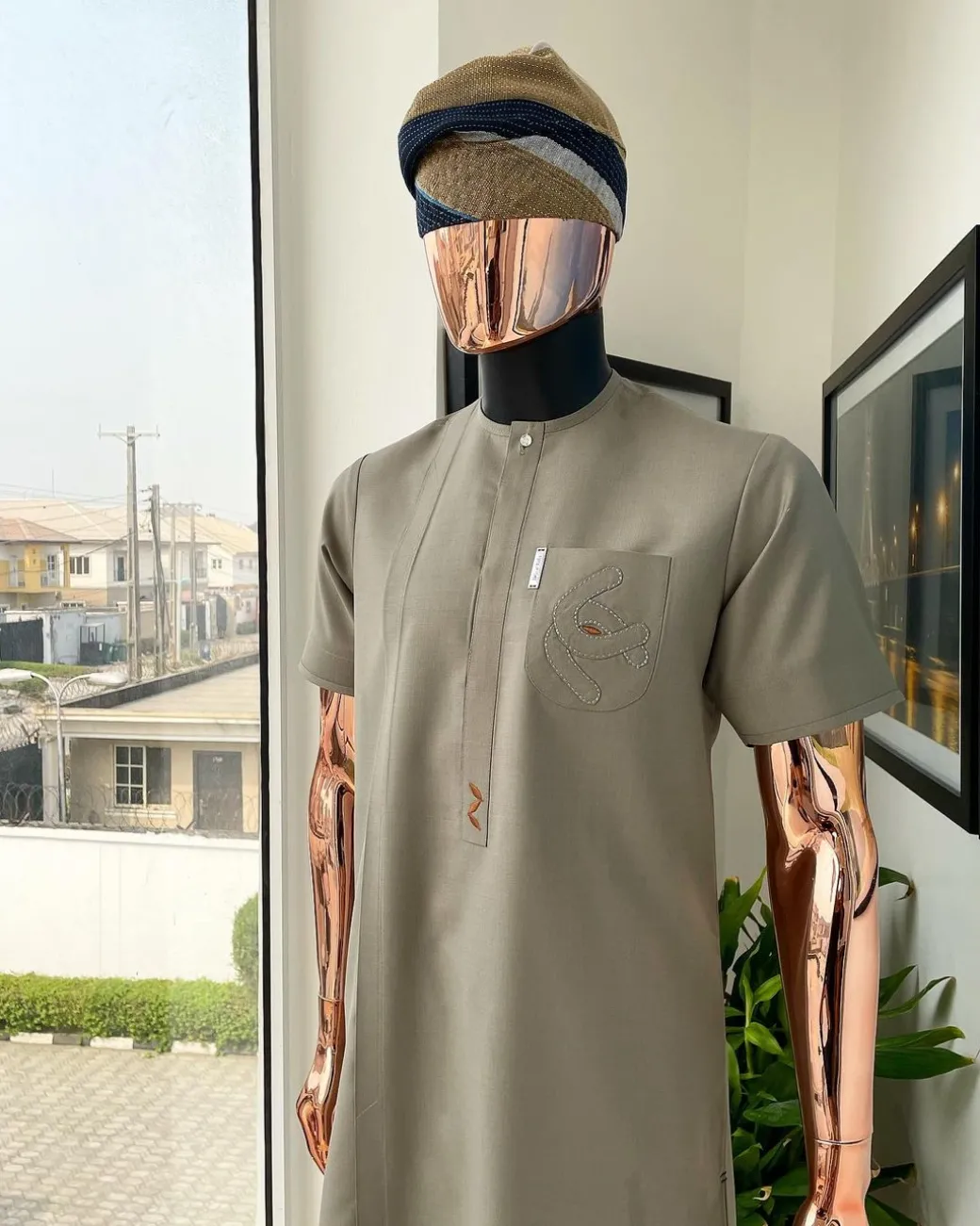 A Sand dollar beige, clear view Swarovski button with orange embroidery flap and pocket detailing African traditional senator kaftan native.